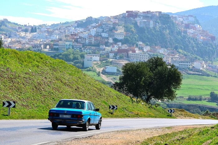 A chauffeur driven car taking a couple to the Holy City of Moulay Idriss on their Morocco honeymoon