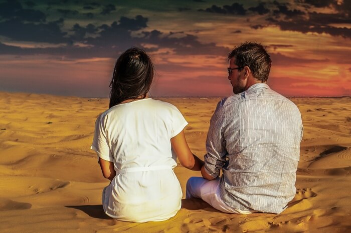 A couple enjoying sunset in the desert