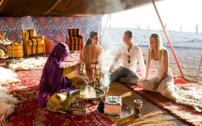 A couple being served welcome drink in Morocco