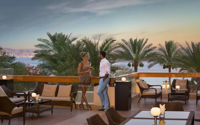 A couple talking on the terrace of a resort near Dead Sea