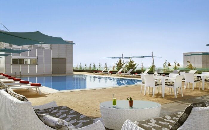 A pool on terrace with sitting area in a resort in Amman