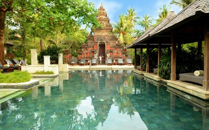 An Indonesian temple near a swimming pool in a resort
