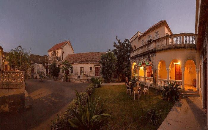 Well-lit open air seating area of Devpur Homestay in Gujarat at dusk