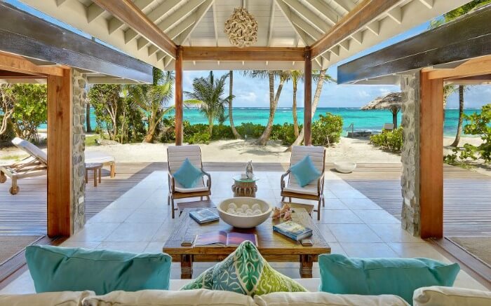 a large cabana with comfortable chairs on the beach