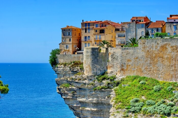 Colorful houses located atop the limestone cliff in Corsica