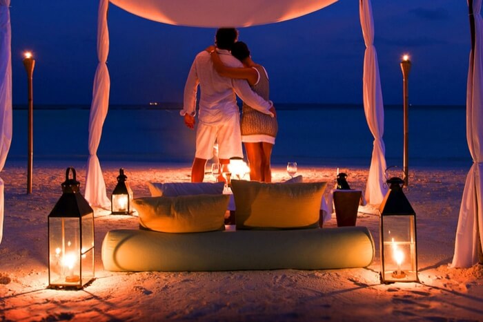 Romantic couple spending private moments by the beach in Maldives