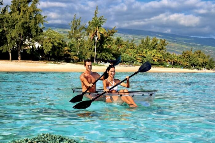 Couple kayaking in a glass boat at Reunion Island