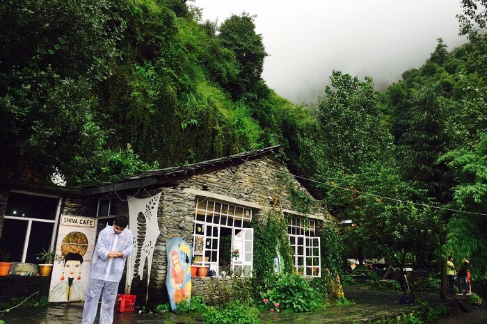 A traveler standing outside the beautiful Shiva Cafe in Mcleodganj