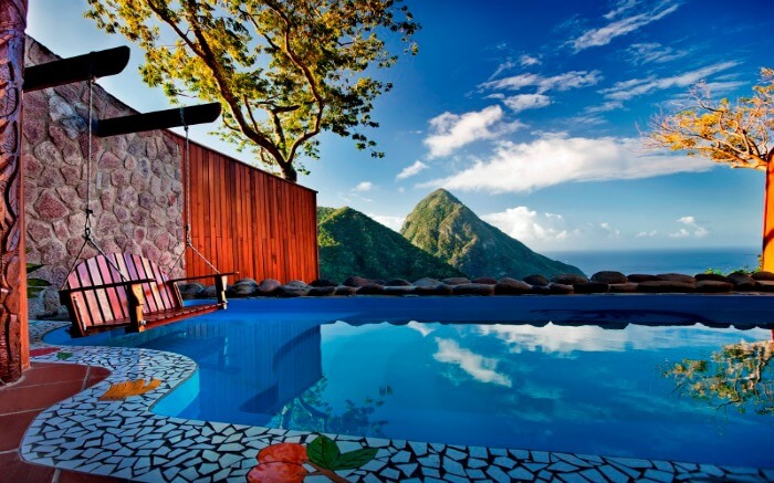 outdoor pool of a resort overlooking conical mountains