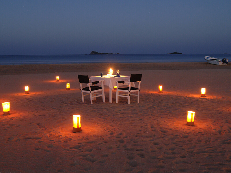 a candlelit dinner on a beach