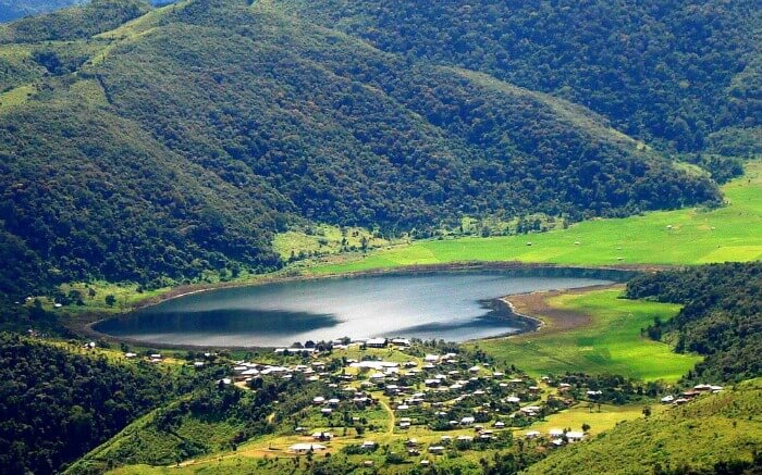 A beautiful lake surrounded by houses and mountains