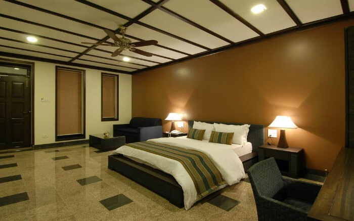 A hotel room with a comfy bed and tablet lights on