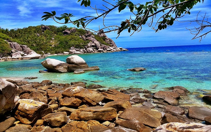 A rocky beach with blue waters