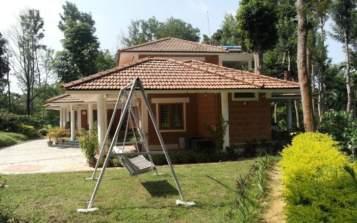 A swing in the garden in front of Casa Coorg Homestay in Coorg