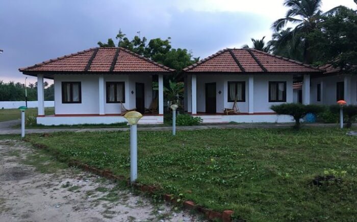 A traditional Lakshadweep style resort with a huge lawn