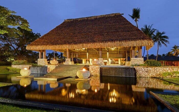 An old style luxurious hut lit at night