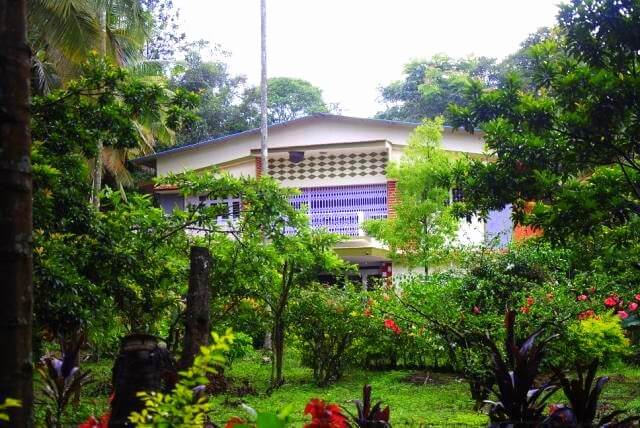a home surrounded by trees and gardens
