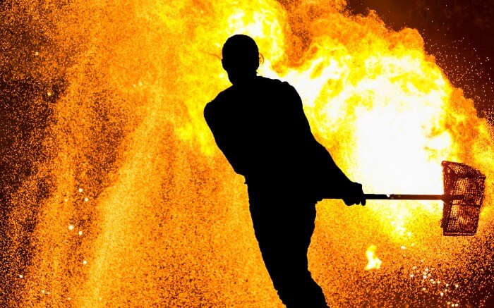 Silhouette of a man performing a fire show