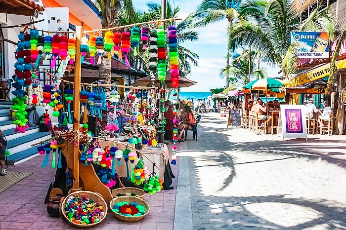 A colorful market area with roadside dining options at Sayulita