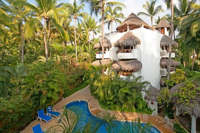 A snap of the swimming pool and hotel building in a jungle setting at the Casablanca Sayulita hotel