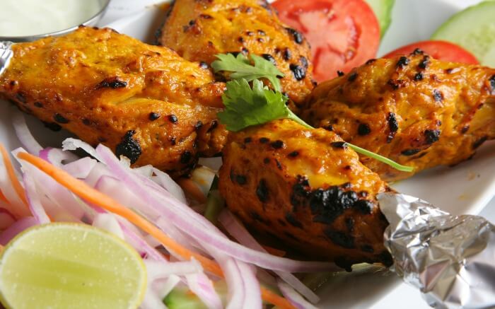 roasted chicken wings with salad on a plate