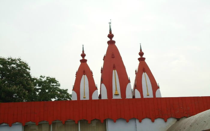 Mankameshwar Temple painted in orange and white colours