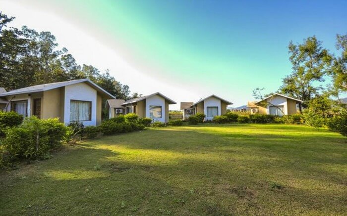 Small cottages with huge green field in a resort