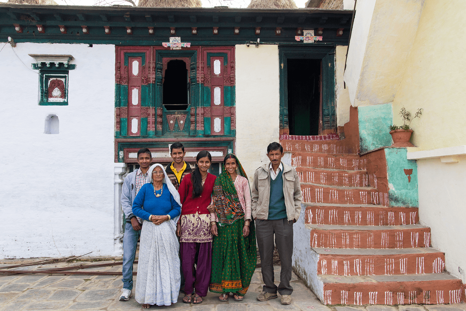 a mountain family standing in their old home ground