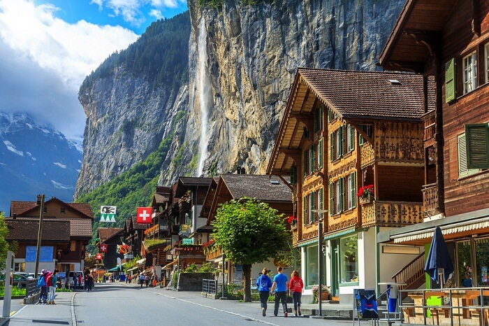 Spectacular principal street of Lauterbrunnen in Interlaken with stunning Staubbach waterfall in background