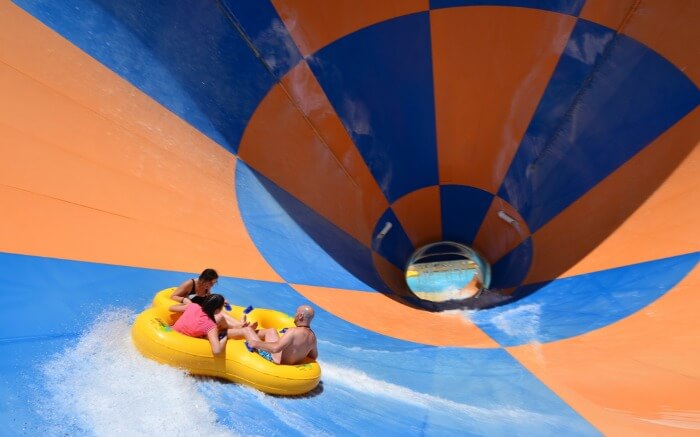 three people enjoying in a water swing in Wet n Wild theme park