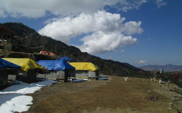 Camps in mountains with yellow and blue roof
