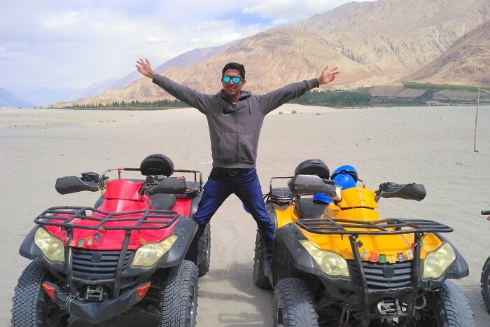 ninad posing on two atv bikes