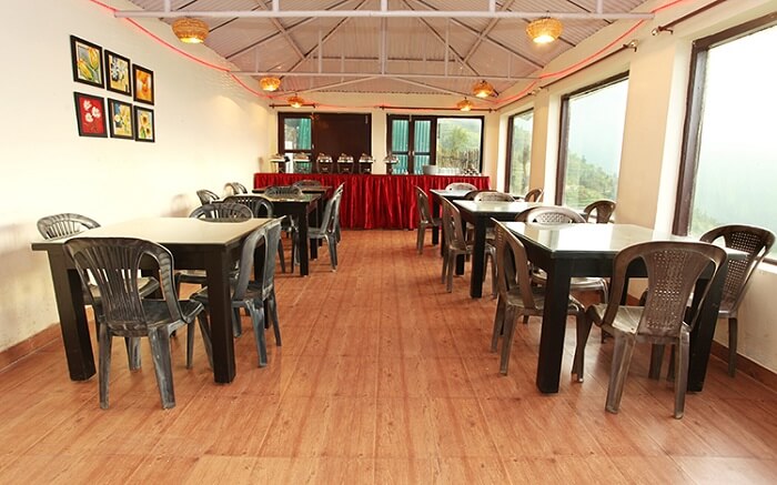 Restaurant with plastic chairs and tables in it