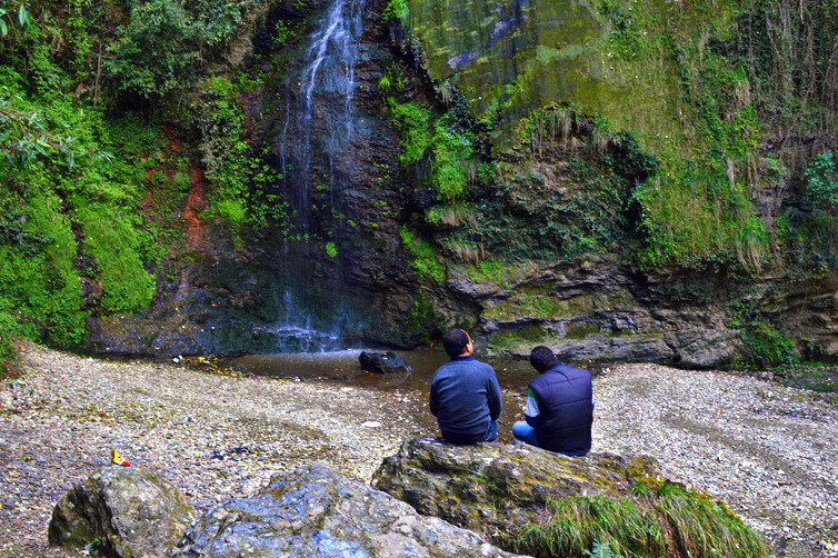 people sitting near the refreshing chadwick falls