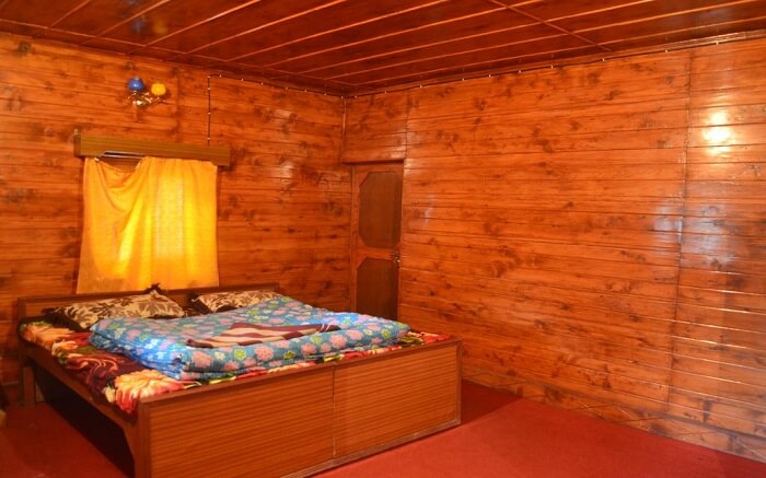 wooden eco hut with a big bed
