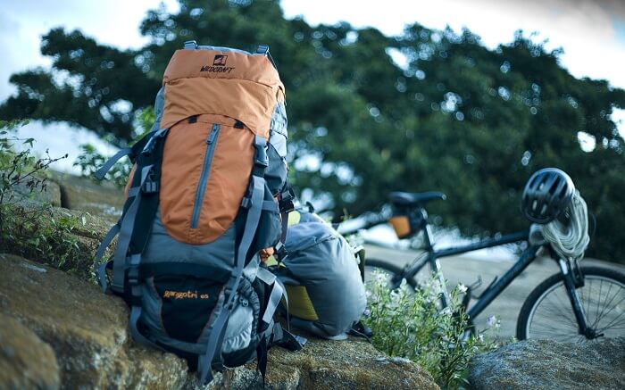 A backpack full of travel essentials kept on a rock ss28102017