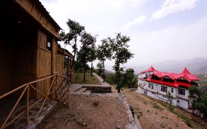 A gorgeous hut style resort overlooking mountains