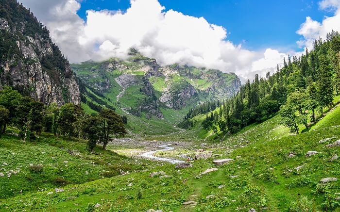 A lush green mountain pass enroute Hampta Pass Trek in Himachal