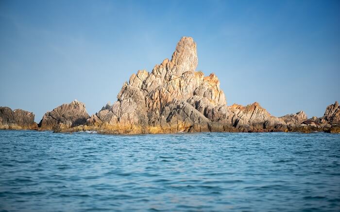 A small rock mountain in ocean