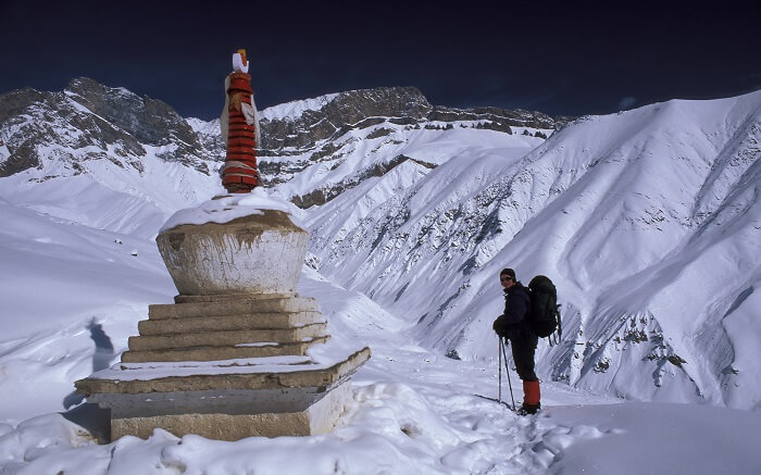 A traveler taking up a winter trek in the Himalayas in Kashmir