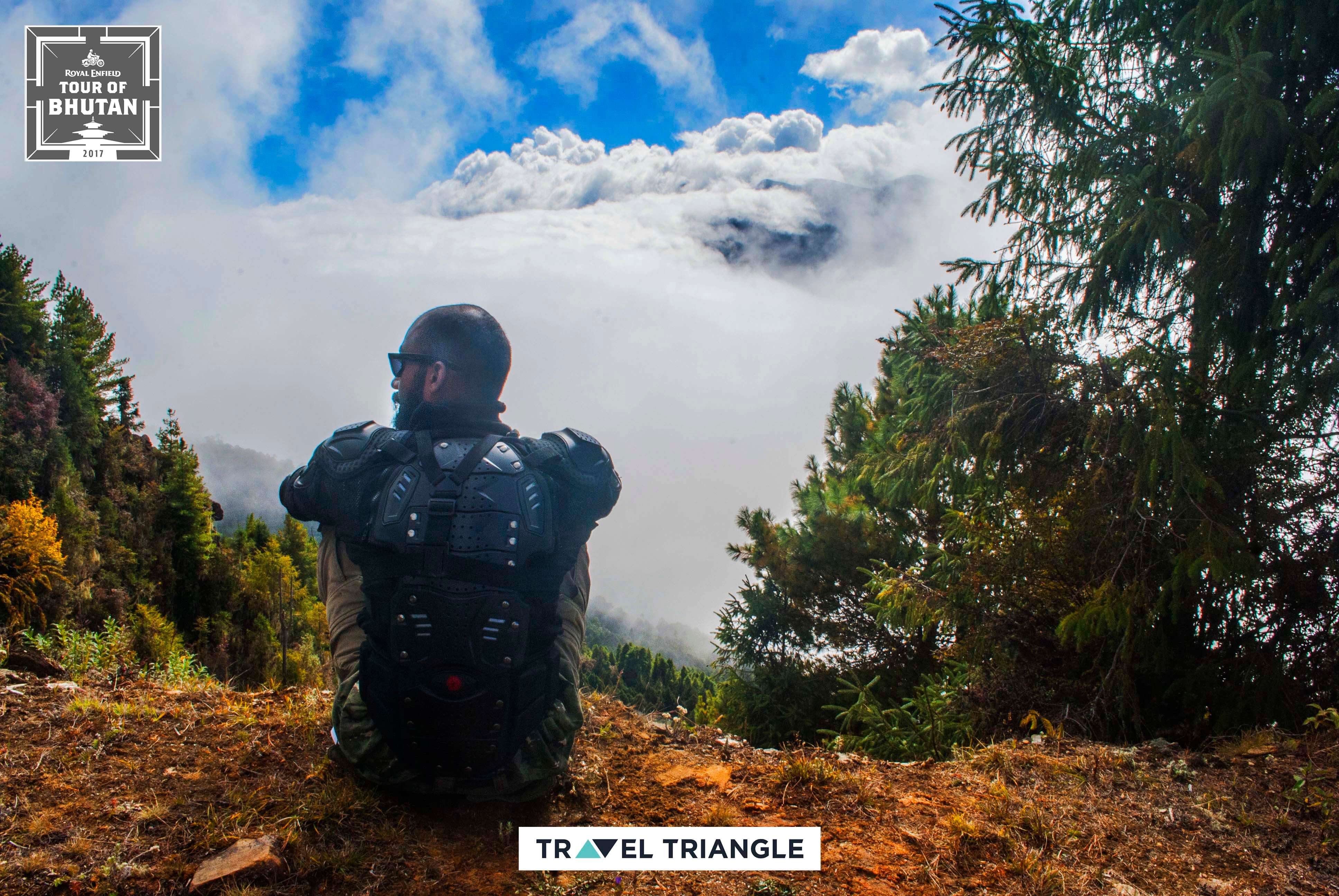 Bumthang to Mongar: siddharth sitting on the edge of a hill