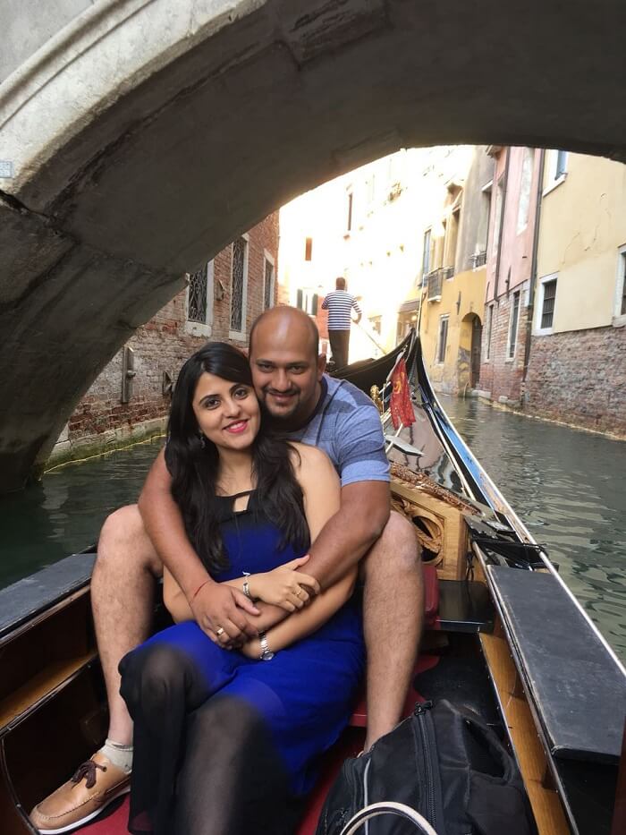 couple taking a gondola ride in venice