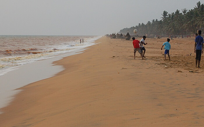 Kids playing on a brown beach