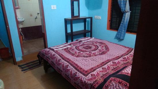 a hotel room with blue walls and a bed