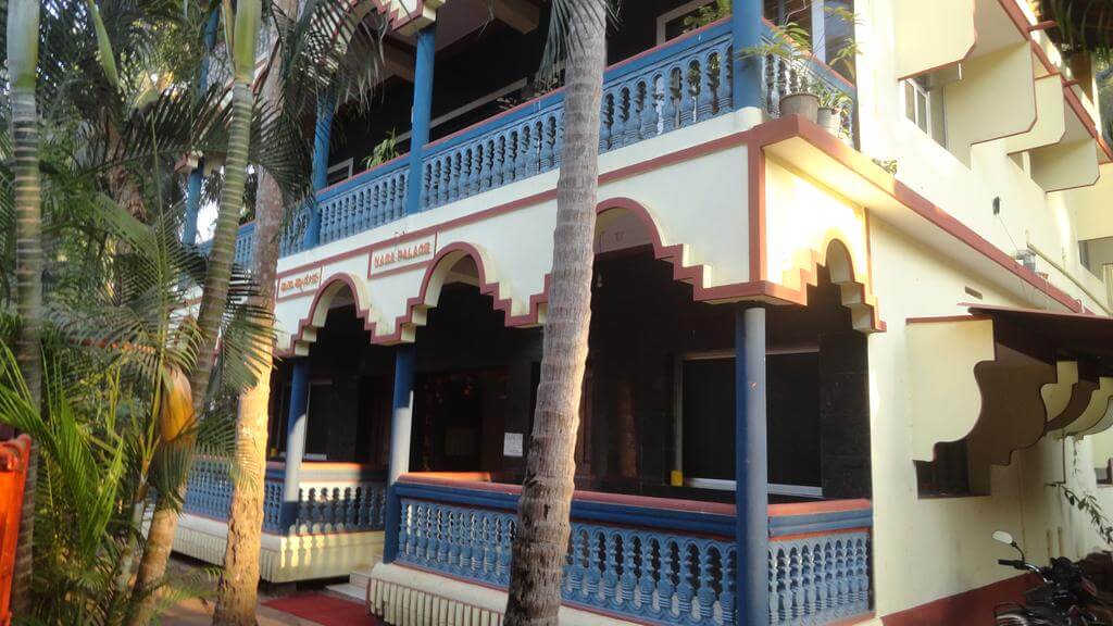 exterior of a hotel surrounded by palm trees