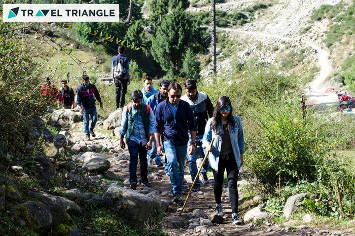 people trekking in the hills
