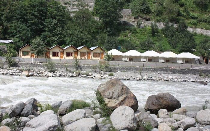Tents of Kia Camps by the river in Manali