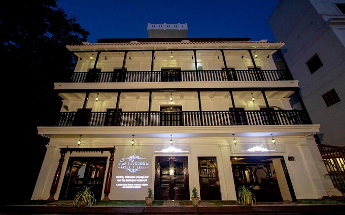 A well lit white traditional hotel building in Pondicherry