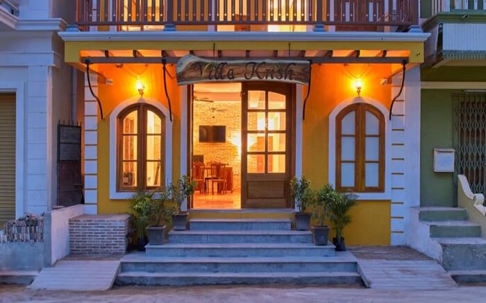 Front of a beautiful well lit hotel at night