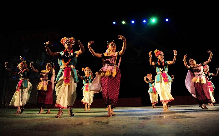 Manipuri people dancing on stage during a festival
